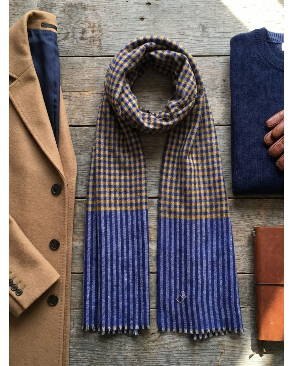 SAMM Pashmina-Schal auf Holz, neben einem camelfarbenen Mantel und einem dunkelblauen Pullover.